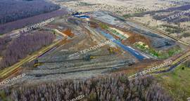 Construction of a reinforced-soil retaining wall and grading of landfill slopes using geosynthetics by «TEXPOLIMER»